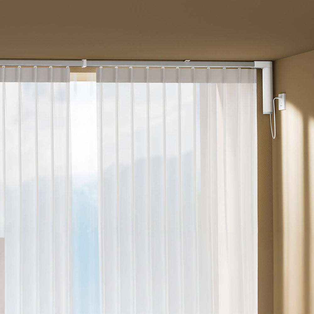 Motor unit fitted at the end of a ceiling curtain track