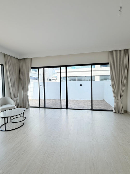 Tailored curtains framing floor-to-ceiling glass in a Dubai villa