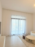 Clean white sheer curtains in a contemporary living room