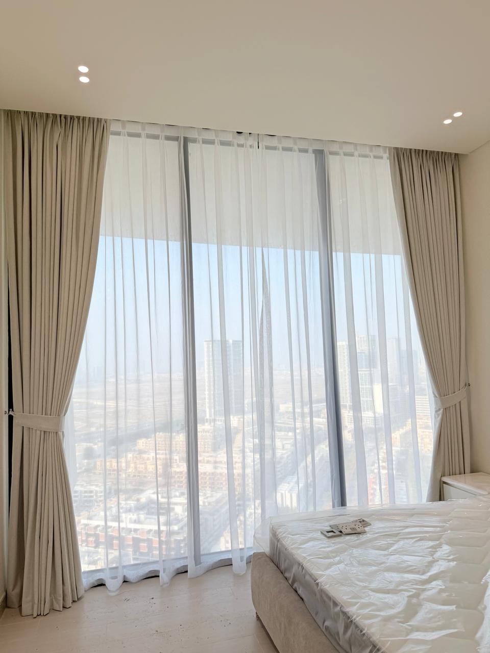 Sheer and blackout curtains in a bedroom