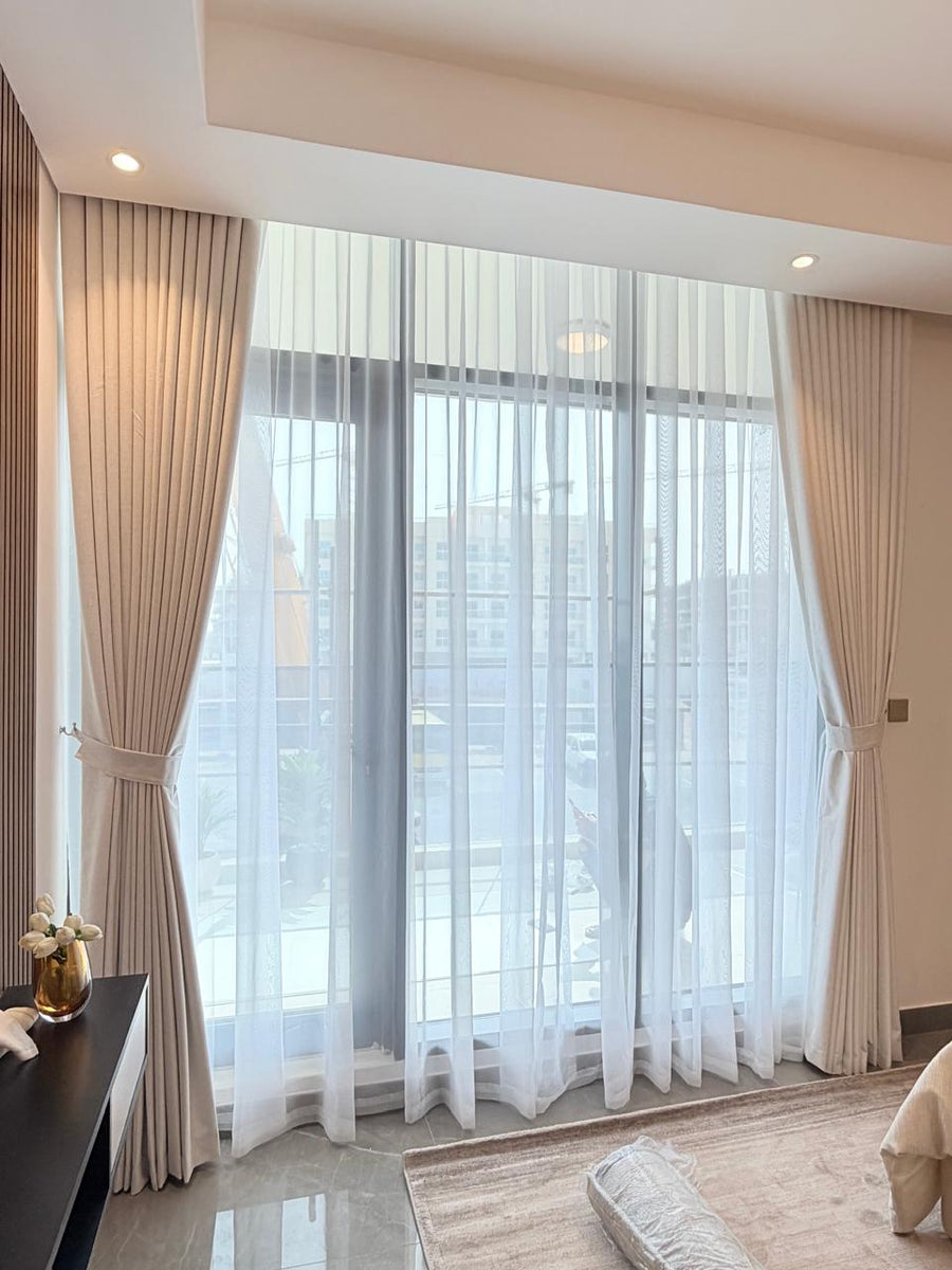 Double-layer curtains on a motorisable track in a living room