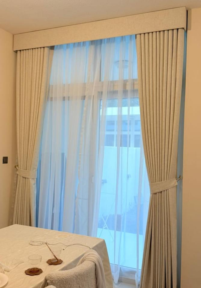 Wave-fold curtains in a bedroom with a city view