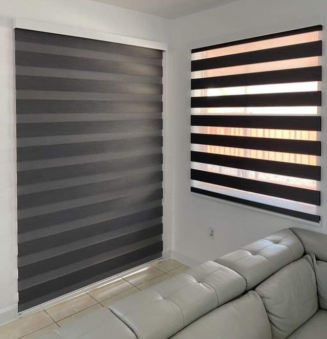 Charcoal zebra blinds at a corner window in a living room